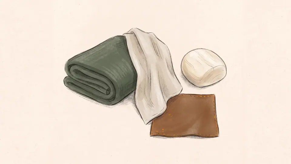 Illustration of wool, linen, wood and leather textures in a still life.